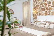 Golden Coast studio with stone wall